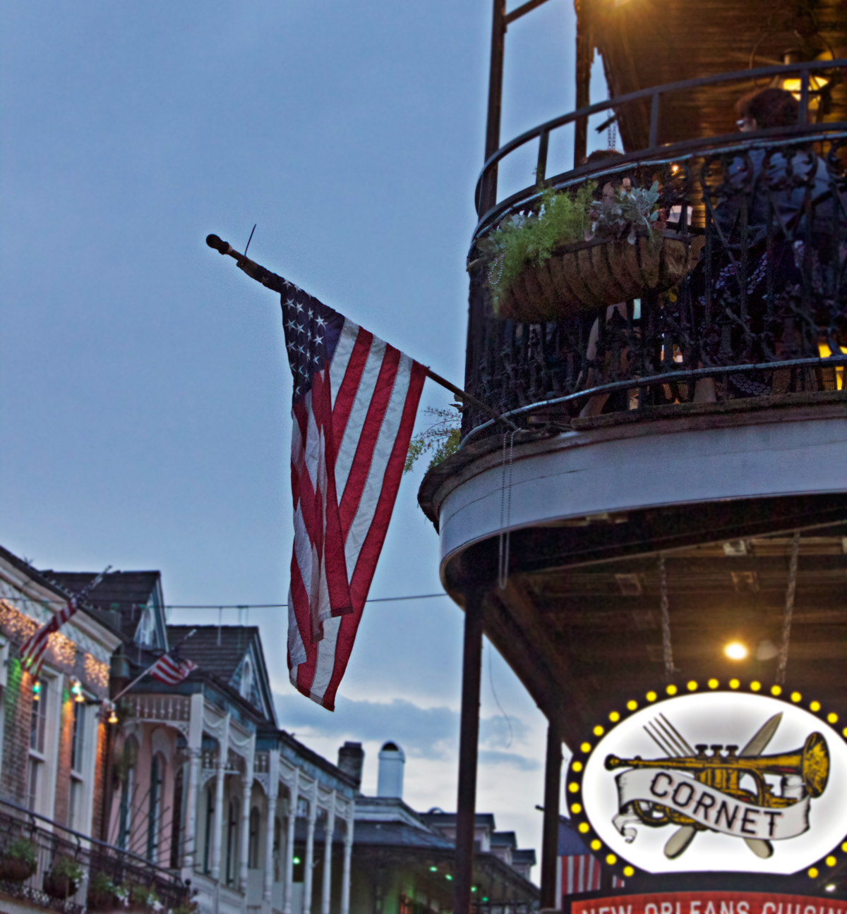 American flag on Bourbon Street -photo by Quiet Lion Creations